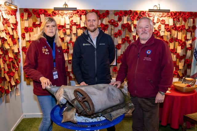 ​Neil White is pictured handing the aircraft part over to Sian Brewis, (left) and Stuart Archibald, Montrose Air Station Heritage Centre chairman.