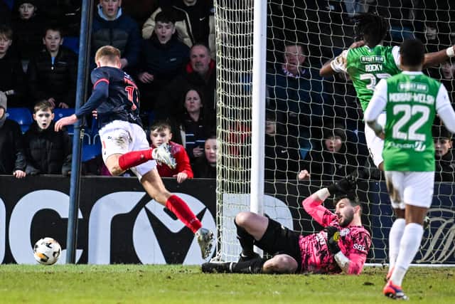 Ross County's Kieran Phillips (L) is brought down in the box by Hibs goalkeeper Jordan Smith, leading to a penalty. (Photo by Rob Casey / SNS Group)