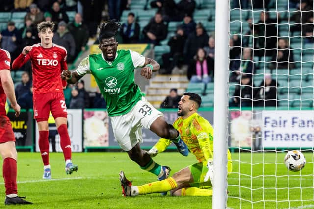 Hibs' Rocky Bushiri nets a dramatic equaliser in a 3-3 draw with Aberdeen.