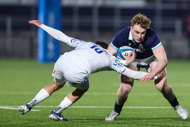 Scotland's Kerr Yule is stopped in his tracks by Italy.