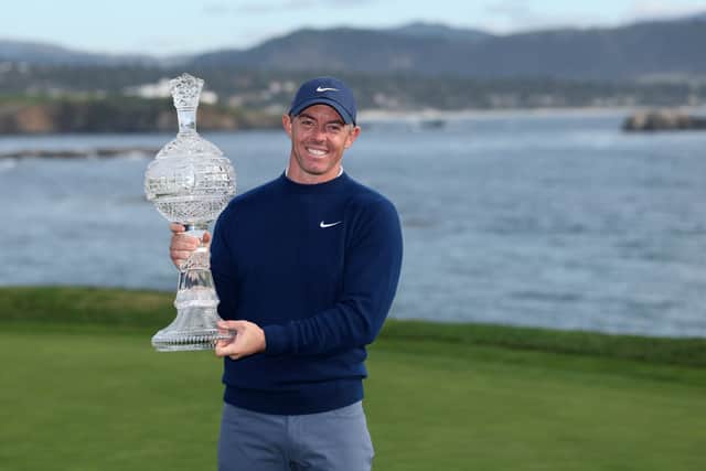 Rory McIlroy shows off the trophy after winning the AT&T Pebble Beach Pro-Am