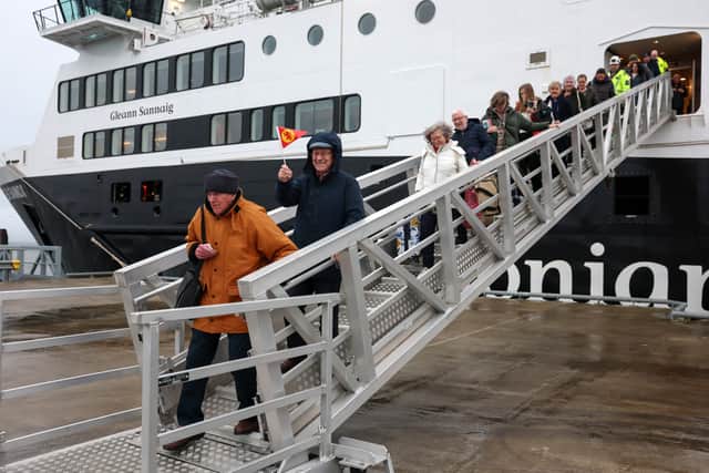 Passengers from Arran disembark in Troon from CalMac’s Glen Sannox ferry on its first official day in service last year