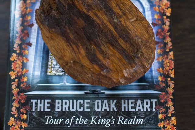 The wooden heart and the new book The Bruce Oak Heart, Tour of the King's Realm , which charts its journey to the Holy Land via Spain. PIC: Lisa Ferguson.