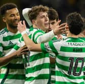 Celtic's Arne Engels (C) celebrates scoring to make it 5-0 over Dundee with teammates Auston Trusty (L) and Nicolas Kuhn.  (Photo by Craig Foy / SNS Group)