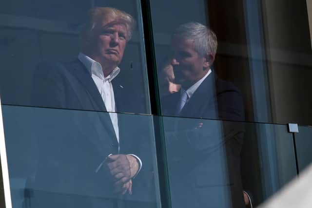 US President Donald Trump speaks with PGA Tour Commissioner Jay Monahan in 2017 