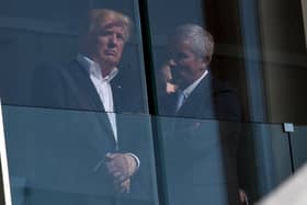US President Donald Trump speaks with PGA Tour Commissioner Jay Monahan in 2017 