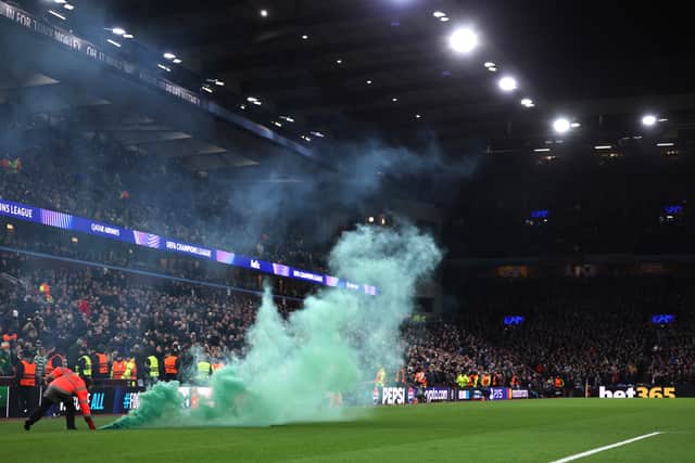 Stewards remove a green flare off the pitch during the Champions League match between Aston Villa and Celtic at Villa Park on January 29, 2025. (Photo by Julian Finney/Getty Images)