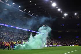 Stewards remove a green flare off the pitch during the Champions League match between Aston Villa and Celtic at Villa Park on January 29, 2025. (Photo by Julian Finney/Getty Images)