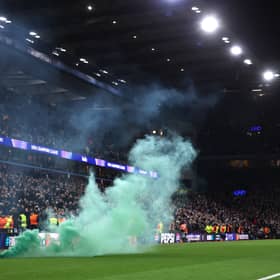 Stewards remove a green flare off the pitch during the Champions League match between Aston Villa and Celtic at Villa Park on January 29, 2025. (Photo by Julian Finney/Getty Images)