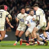 Elliot Daly of England celebrates with team mates after scoring their late fourth try in the Six Nations win over France.