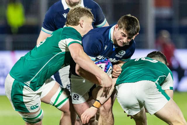 Scotland's Seb Stephen (C) and Ireland's Billy Corrigan (L) and Sam Wisniewski in action at Hive Stadium.