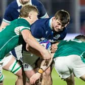 Scotland's Seb Stephen (C) and Ireland's Billy Corrigan (L) and Sam Wisniewski in action at Hive Stadium.