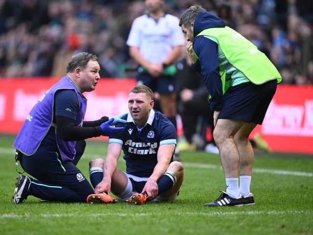 Finn Russell receives medical treatment following his collision with Scotland team-mate Darcy Graham.