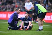 Finn Russell receives medical treatment following his collision with Scotland team-mate Darcy Graham.