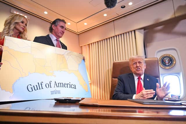 Donald Trump shows off a map of his 'Gulf of America' on board Air Force One while flying to New Orleans for the Super Bowl (Picture: Roberto Schmidt)