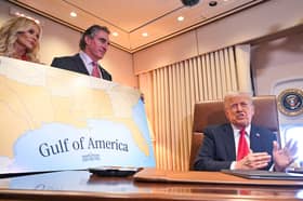 Donald Trump shows off a map of his 'Gulf of America' on board Air Force One while flying to New Orleans for the Super Bowl (Picture: Roberto Schmidt)
