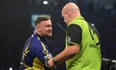 Luke Littler congratulates Michael van Gerwen on his victory during the opening night of the Premier League Darts season at The SSE Arena Belfast