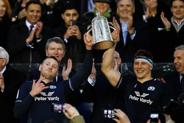 Finn Russell and Rory Darge of Scotland lift the Calcutta Cup after defeating England during the Guinness Six Nations 2024 match between Scotland and England at BT Murrayfield Stadium on February 24, 2024.