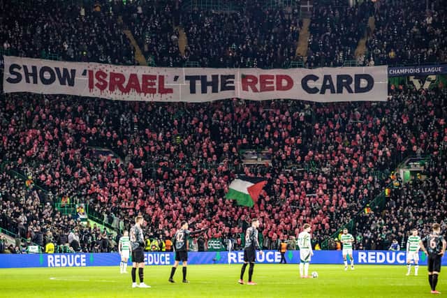 Celtic fans unveil a banner which reads 'show Israel the red card' during the Champions League play-off first leg match against Bayern Munich at Celtic Park.  (Photo by Craig Williamson / SNS Group)