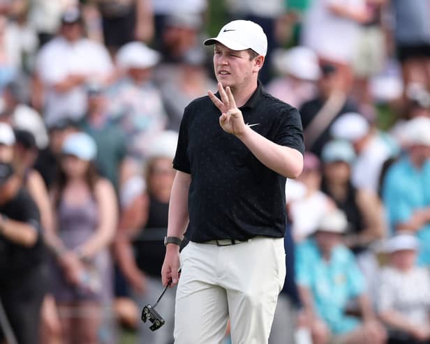 Bob MacIntyre of Scotland gestures on the 18th green during the final round of the WM Phoenix Open in Scottsdale, Arizona. 