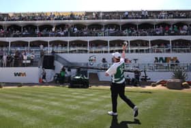 Bob MacIntyre throws a bundle containing an Oban Celtic top and a $20 note into the crowd at TPC Scottsdale 