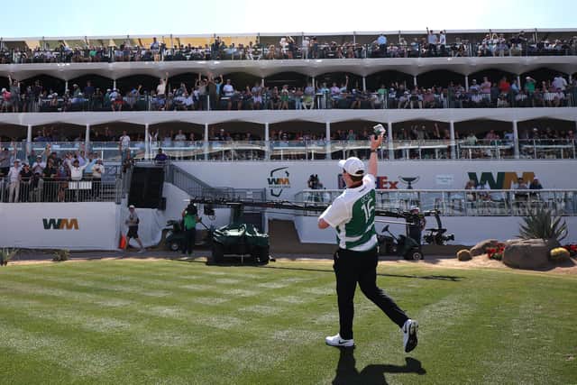 Bob MacIntyre throws a bundle containing an Oban Celtic top and a $20 note into the crowd at TPC Scottsdale 