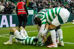Jota is mobbed by his teammates after scoring against Dundee United.