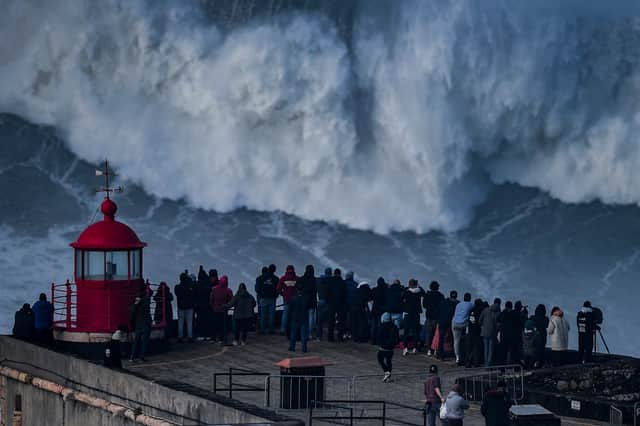 Surf spectators at Praia do Norte in Nazare, home of the Nazare Big Wave Challenge