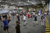 Here are all the details about the Royal Navy's Pre-Joining fitness test, and how you can beat it. Pictured are HMS Queen Elizabeth's ship's company take part in circuits in the hangar.