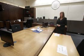 Yvonne Taylor, operational director for Scottish Courts and Tribunals, shows social distance measures in courtroom five at Glasgow Sheriff Court during the Covid-19 pandemic