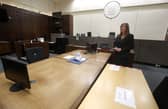 Yvonne Taylor, operational director for Scottish Courts and Tribunals, shows social distance measures in courtroom five at Glasgow Sheriff Court during the Covid-19 pandemic