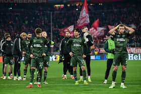 Celtic players react after the the 1-1 draw in Munich that ended their Champions League adventure. (Photo by TOBIAS SCHWARZ/AFP via Getty Images)          