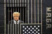 A piece of street art in the Gorbals, Glasgow, by artist Ashley Rawson, showing US president Donald Trump behind bars (Picture: Jane Barlow)