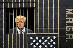 A piece of street art in the Gorbals, Glasgow, by artist Ashley Rawson, showing US president Donald Trump behind bars (Picture: Jane Barlow)