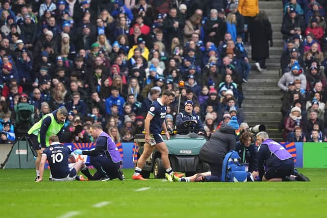 Scotland's Finn Russell, left, and Scotland's Darcy Graham, right, are treated following the clash of heads against Ireland.
