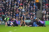 Scotland's Finn Russell, left, and Scotland's Darcy Graham, right, are treated following the clash of heads against Ireland.