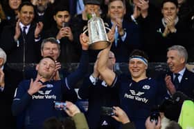 Co-captains Finn Russell and Rory Darge lift the Calcutta Cup after the win over England at Murrayfield in 2024.