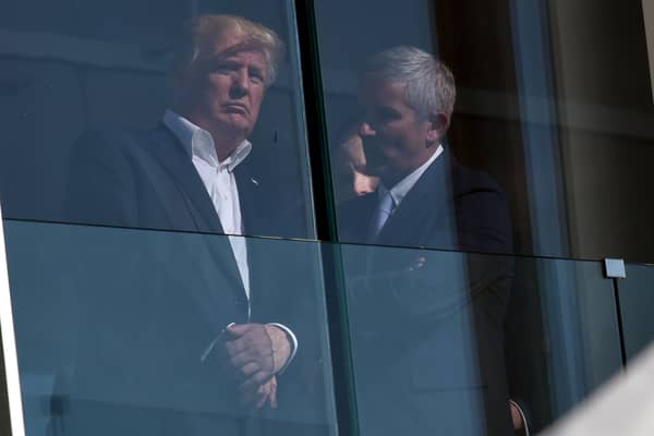 US President Donald Trump speaks with PGA Tour Commissioner Jay Monahan in 2017 