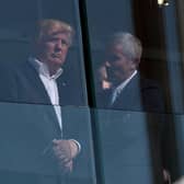 US President Donald Trump speaks with PGA Tour Commissioner Jay Monahan in 2017 