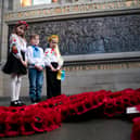 Representatives of the Children of Ukraine (from left) Varvara Tkachenko, Olexander Pidhirnyi and Ylesaveta Pidhirnyi during a service to mark the third anniversary of Russia's invasion of Ukraine at the Scottish National War Memorial, Edinburgh Castle.