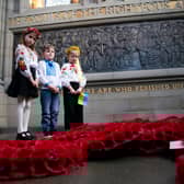 Representatives of the Children of Ukraine (from left) Varvara Tkachenko, Olexander Pidhirnyi and Ylesaveta Pidhirnyi during a service to mark the third anniversary of Russia's invasion of Ukraine at the Scottish National War Memorial, Edinburgh Castle.
