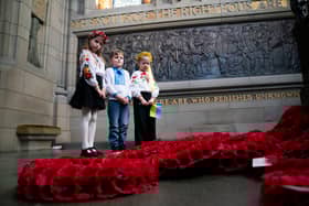 Representatives of the Children of Ukraine (from left) Varvara Tkachenko, Olexander Pidhirnyi and Ylesaveta Pidhirnyi during a service to mark the third anniversary of Russia's invasion of Ukraine at the Scottish National War Memorial, Edinburgh Castle.