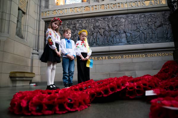 Representatives of the Children of Ukraine (from left) Varvara Tkachenko, Olexander Pidhirnyi and Ylesaveta Pidhirnyi during a service to mark the third anniversary of Russia's invasion of Ukraine at the Scottish National War Memorial, Edinburgh Castle.