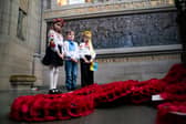 Representatives of the Children of Ukraine (from left) Varvara Tkachenko, Olexander Pidhirnyi and Ylesaveta Pidhirnyi during a service to mark the third anniversary of Russia's invasion of Ukraine at the Scottish National War Memorial, Edinburgh Castle.