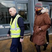Dr Beth Upton covers her face with a scarf while leaving the employment tribunal in Dundee involving nurse Sandie Peggie and NHS Fife (Picture: Andrew Milligan)