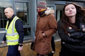 Dr Beth Upton covers her face with a scarf while leaving the employment tribunal in Dundee involving nurse Sandie Peggie and NHS Fife (Picture: Andrew Milligan)