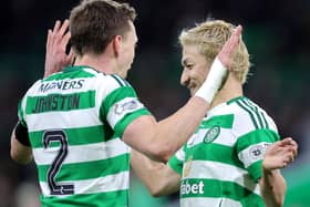 Alistair Johnston and Daizen Maeda celebrate the Celtic win over Aberdeen.