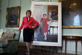 First Minister Nicola Sturgeon stands next to her life size portrait by Gerard M Burns, at Bute House in 2015.