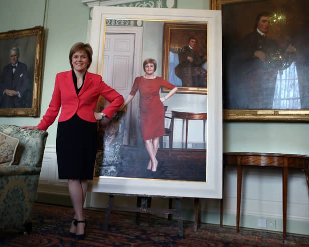First Minister Nicola Sturgeon stands next to her life size portrait by Gerard M Burns, at Bute House in 2015.