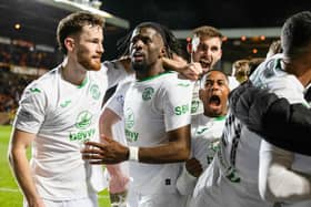 Hibs players celebrate after Junior Hoilett scored to make it 3-1 over Dundee United at Tannadice. (Photo by Ross Parker / SNS Group)